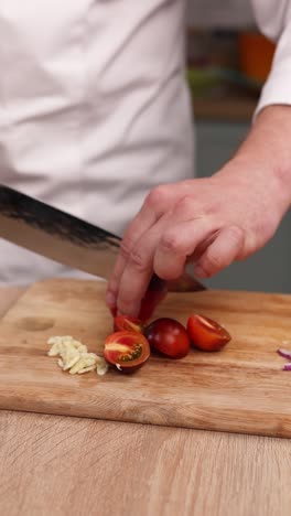 chef chopping tomatoes and garlic