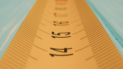 Roll-of-measuring-tape-in-motion-macro