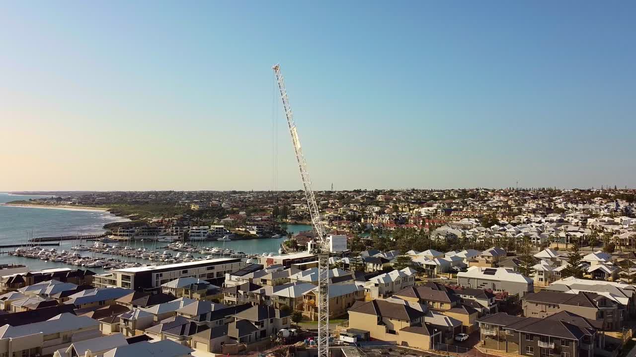Aerial View of Coastal Construction Site with Crane