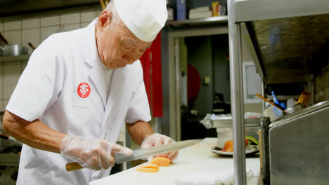 male chef cutting sushi in kitchen 4k