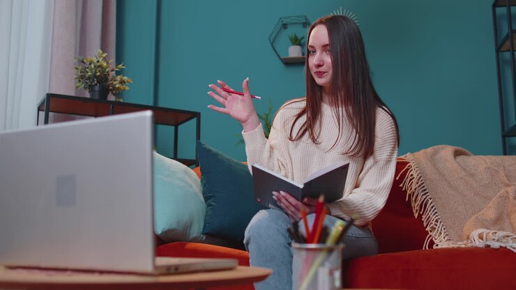 Young woman teacher freelancer consult student by laptop use modern tech for elearning at home room