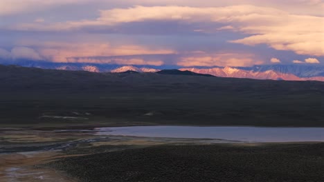 benton crossing long valley caldera mammoth lakes convict canyon minarets sierra nevada mountains hilltop wild willy's hot springs california aerial drone winter vibrant sunset clouds upwards motion