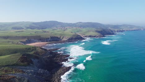 full view on playa de tagle and beautiful green hills seen from the bay of biscay