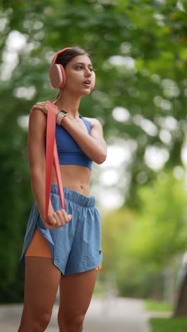 woman stretching with resistance band outdoors