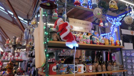 santa claus miniature toy is climbing on rope, on christmas market stall