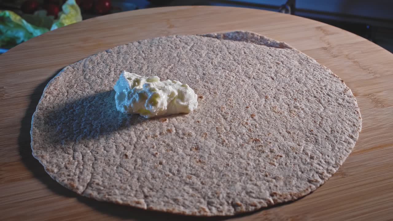 unte queso bajo en grasa y mayonesa sobre la envoltura de tortilla, luego rellene con pavo molido cocido, tomates cherry, pepinillos y hojas frescas para ensalada