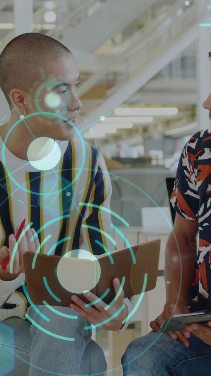 Vertical video: Two men turning pages and tapping tablet, teal AR overlay guiding business review