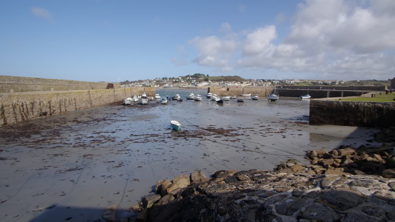 Extra wide shot of the tide out in St Michael's mount harbour entrance