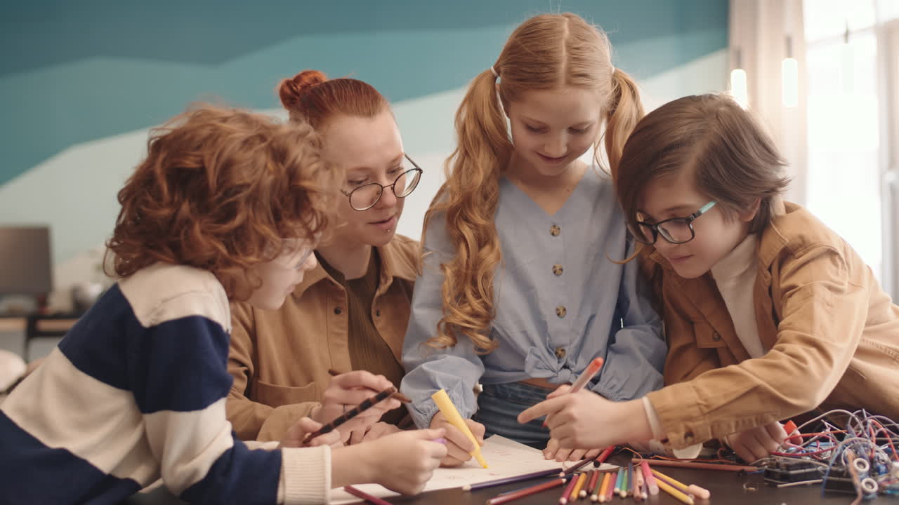 Teacher and Pupils Drawing Robot Scheme on Paper Sheet