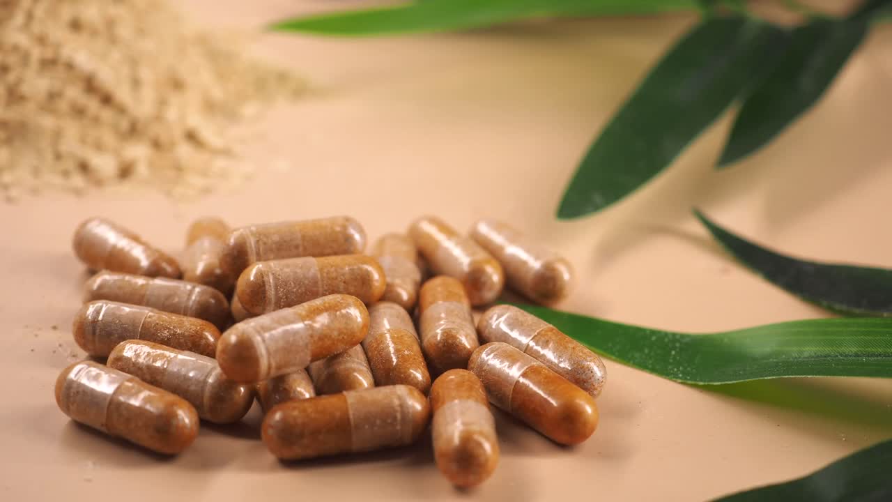 Natural Herbal Supplement Pills with Powder and Green Leaves