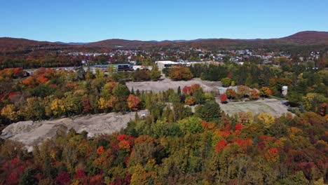 Experience-breathtaking-views-as-a-drone-soars-above-a-lush-forest,-capturing-majestic-mountains-in-the-distant-backdrop