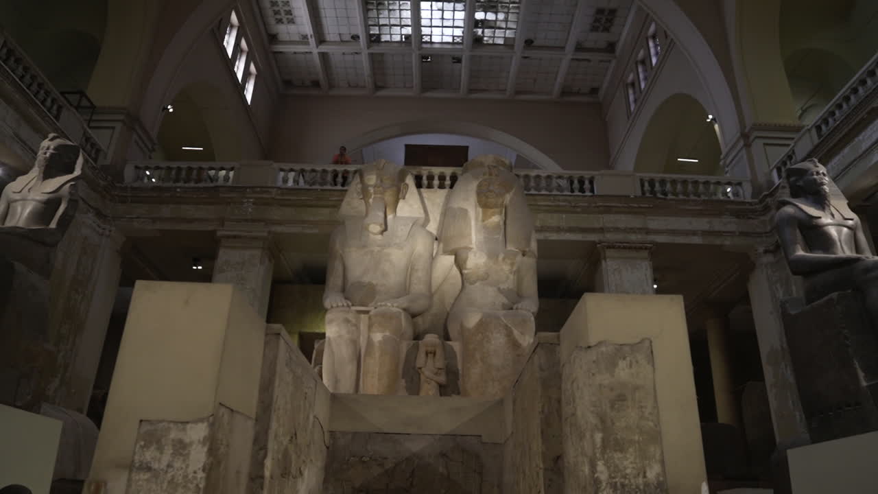 Pushing in shot panning up to massive ancient statues in Egyptian museum