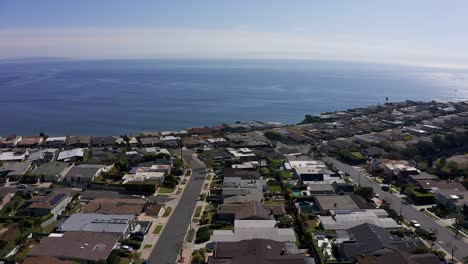 Aerial-reverse-pullback-shot-of-a-housing-community-on-the-bluffs-above-Malibu,-California