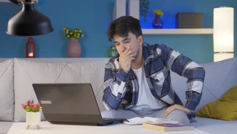 stressed and depressed male student at home at night.