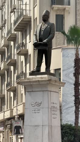 a view of talat harb statue, close up shot, low angle shot