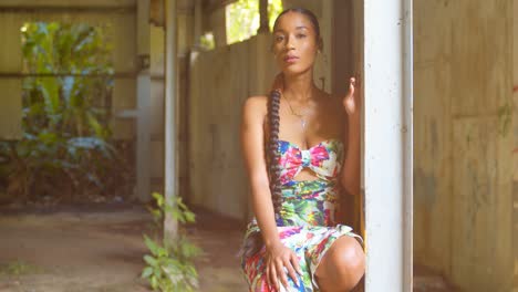 360-pan-of-a-African-girl-squating-on-a-beam-in-an-abandoned-warehouse-with-grafitti-art-in-the-background