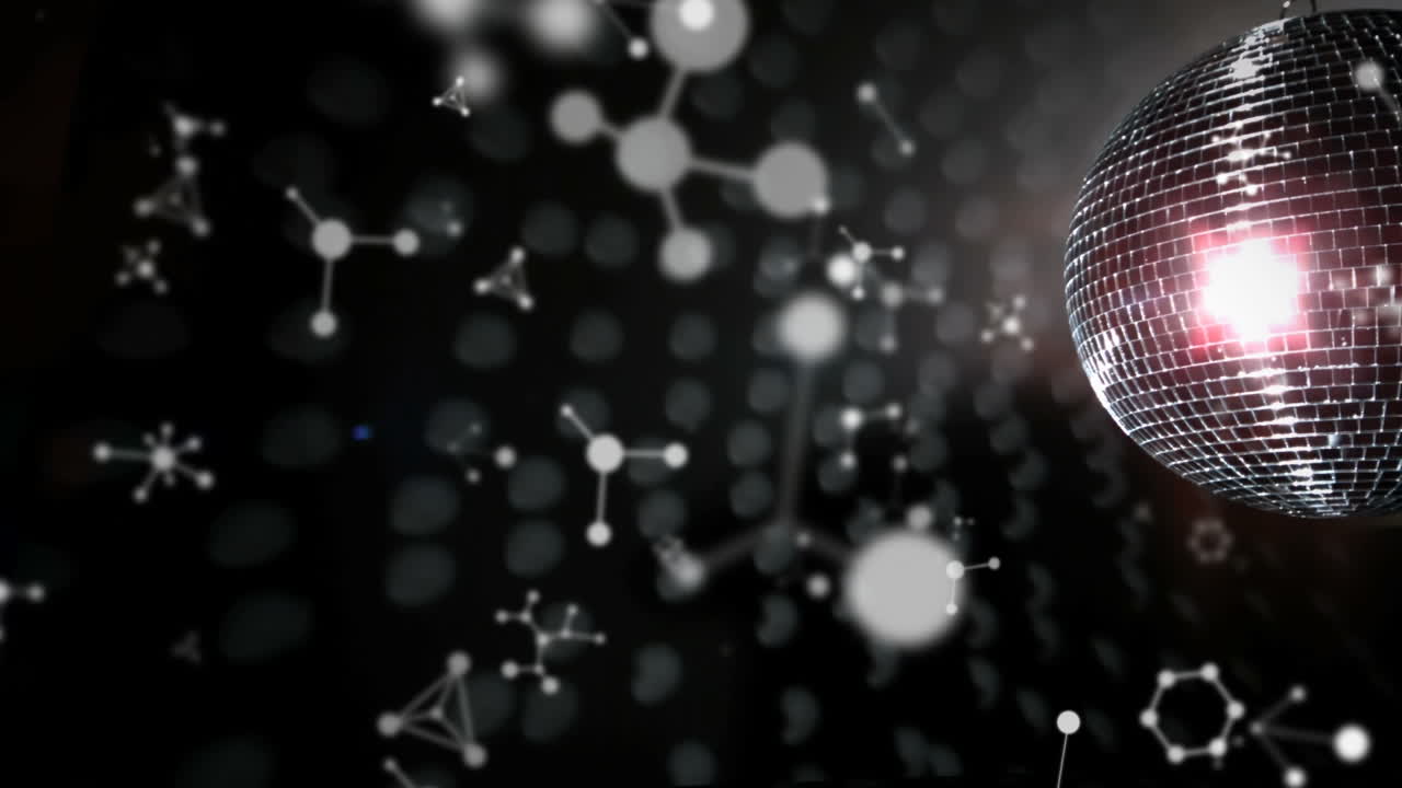 animación de moléculas que caen sobre una bola de discoteca brillante sobre un fondo oscuro