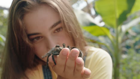 nature girl holding tarantula spider at zoo enjoying excursion to wildlife sanctuary student having fun learning about arachnids 4k