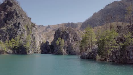 calm waters of oymapinar dam at green canyon surrounded by rocky mountain in manavgat, antalya, turkey