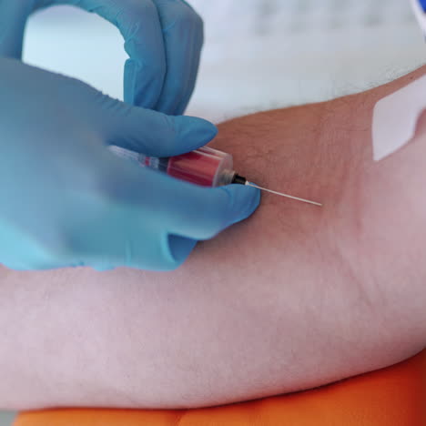 nurse collecting blood from patient vein into syringe.the process of blood sampling from the vein for examination. close-up.