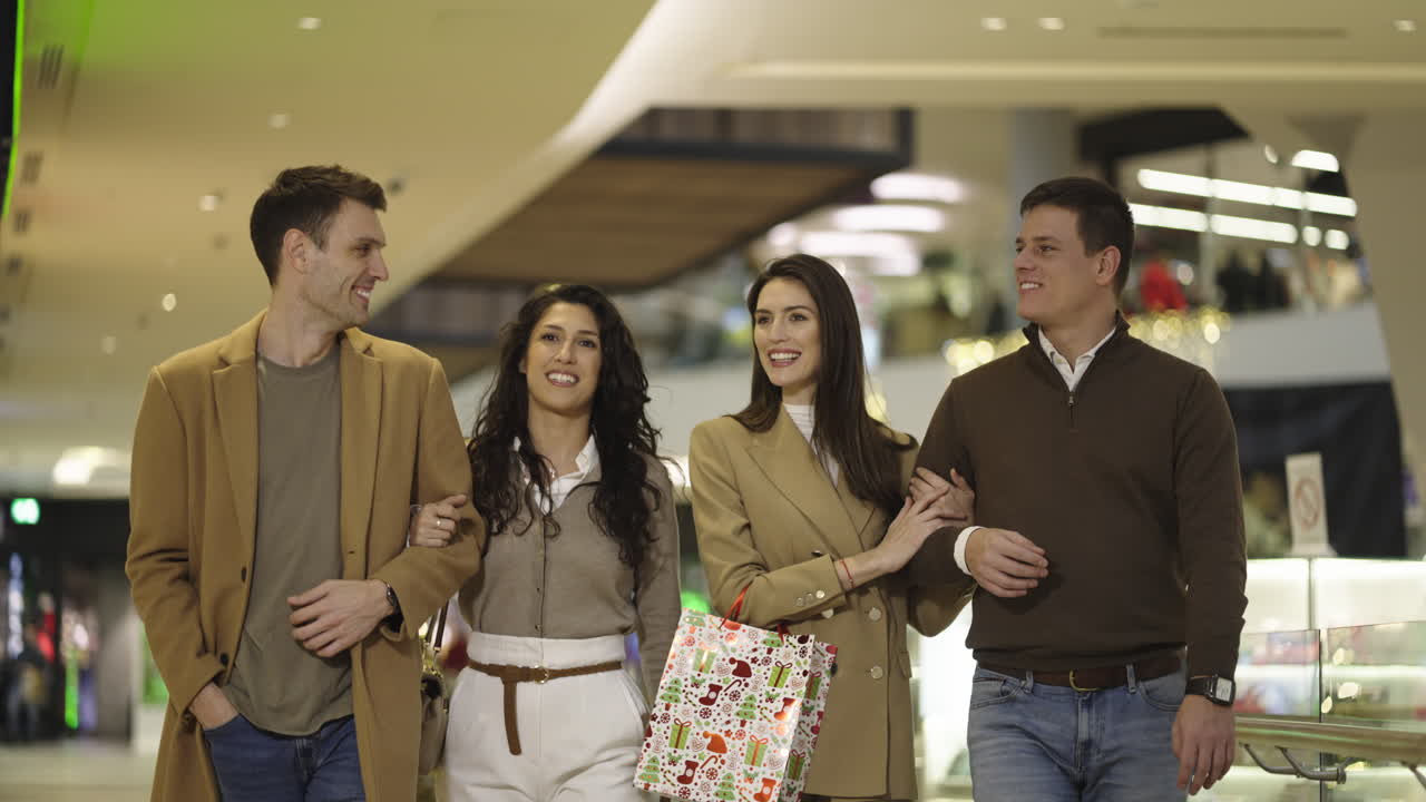 Friends or couples enjoying a shopping trip in a modern mall