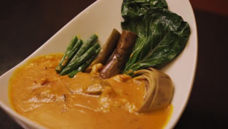 kare-kare bowl - philippine pork dish with vegetables in peanut sauce