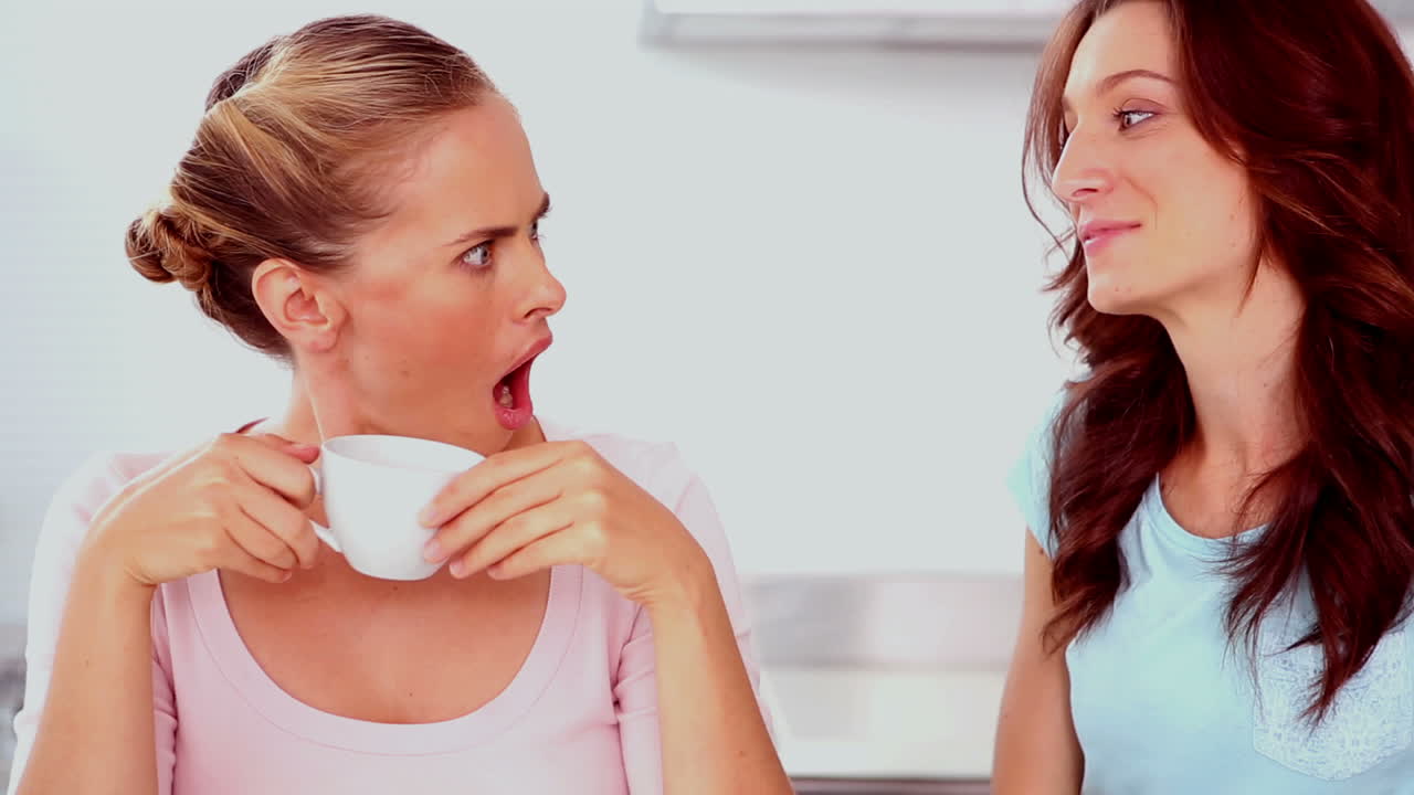 Woman telling her friend a secret