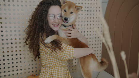 woman hugging her shiba inu dog