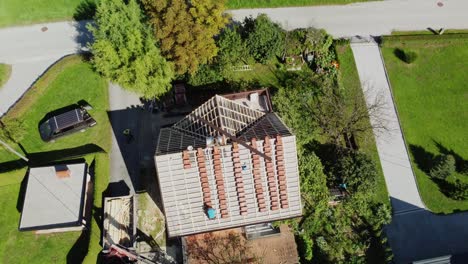 drone push in tilt down above neat columns of red roofing tiles on house