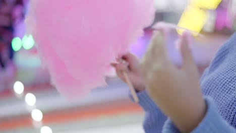 woman eating cotton candy