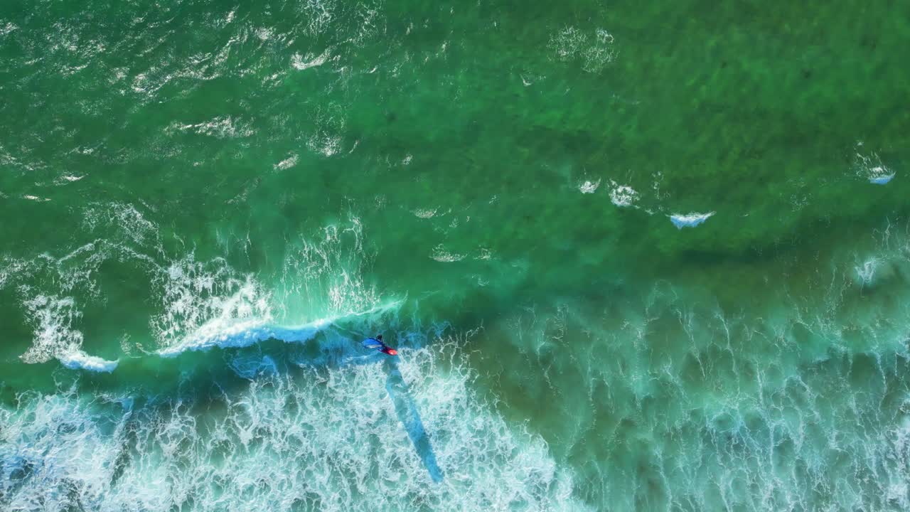 A windsurfer riding the waves at Guincho beach.Guincho It is very windy and offers excellent conditions for surfing, kitesurfing and windsurfing.Cascais,Portugal