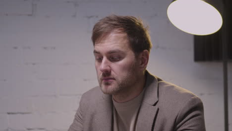 stressed businessman checking time, closing laptop computer and leaving the meeting room