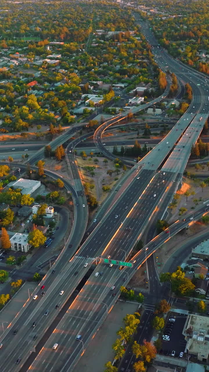 Huge impressive road junction in the city of Sacramento, California, USA. Vast urban panorama of green city from top view. Vertical video