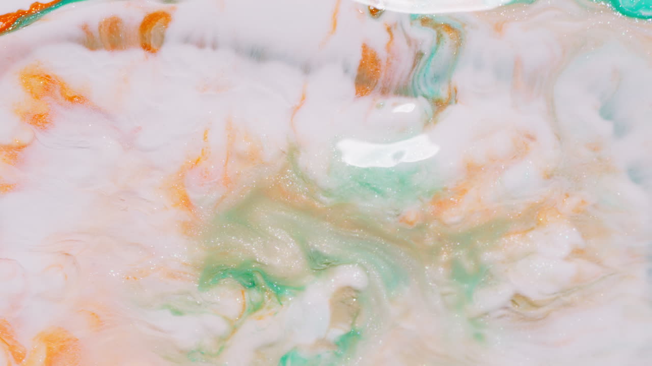 Vibrant macro shot of colorful ink swirling in water, creating patterns