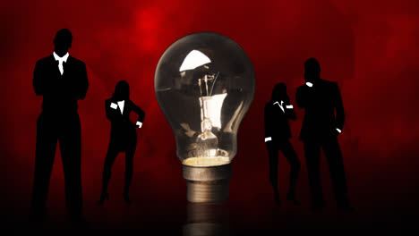 business people silhouettes around a lightbulb. concept of clever