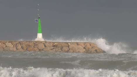 crashing waves and stormy seas on harbor wall