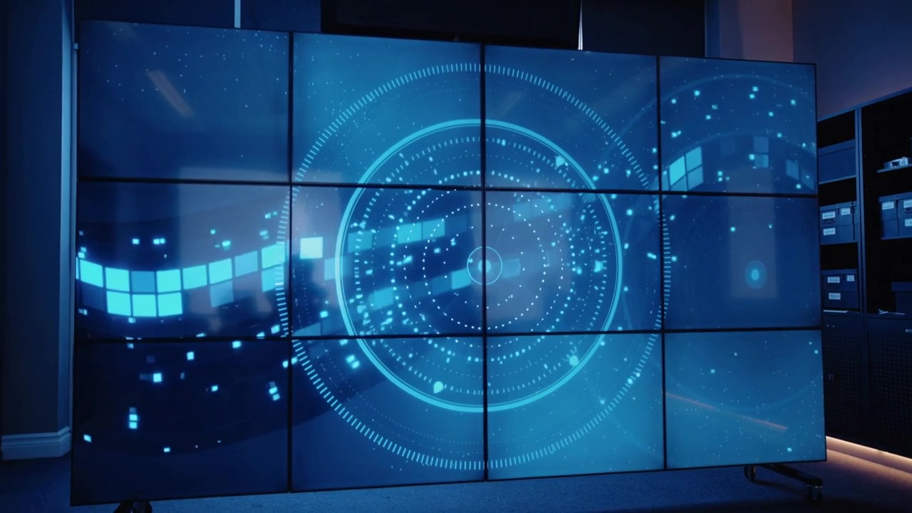 Animating multi-panel display wall pulsing blue HUD rings with tile band starting left
