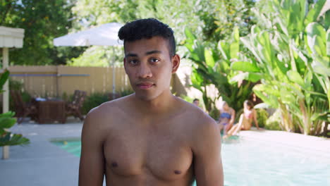 Portrait-Of-Bare-Chested-Man-Outdoors-With-Friends-Enjoying-Summer-Pool-Party