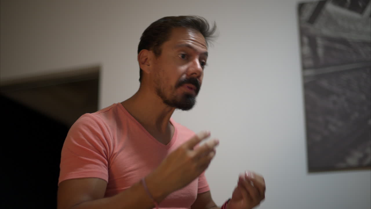 Slow motion of a latin man with beard playing a game acting as if he was eating and chewing trying to express a concept idea