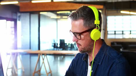 man listening to music while working on computer