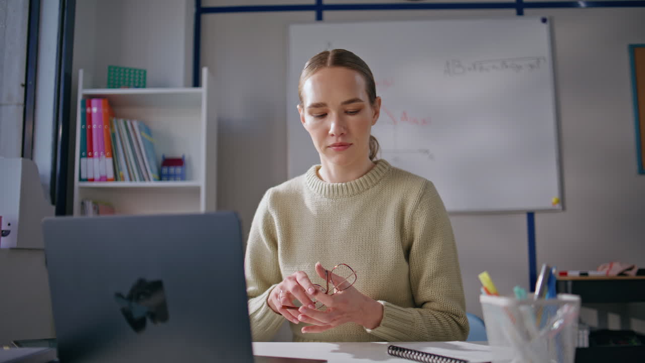 Professional teacher conducting online training sitting modern cabinet closeup