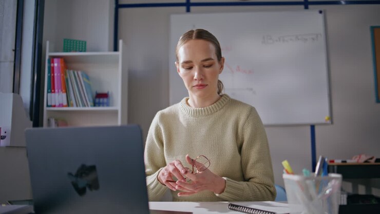 Professional teacher conducting online training sitting modern cabinet closeup