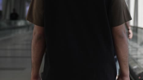 man wearing tshirt walking in slow motion while at dubai mall shopping in the united arab emirates
