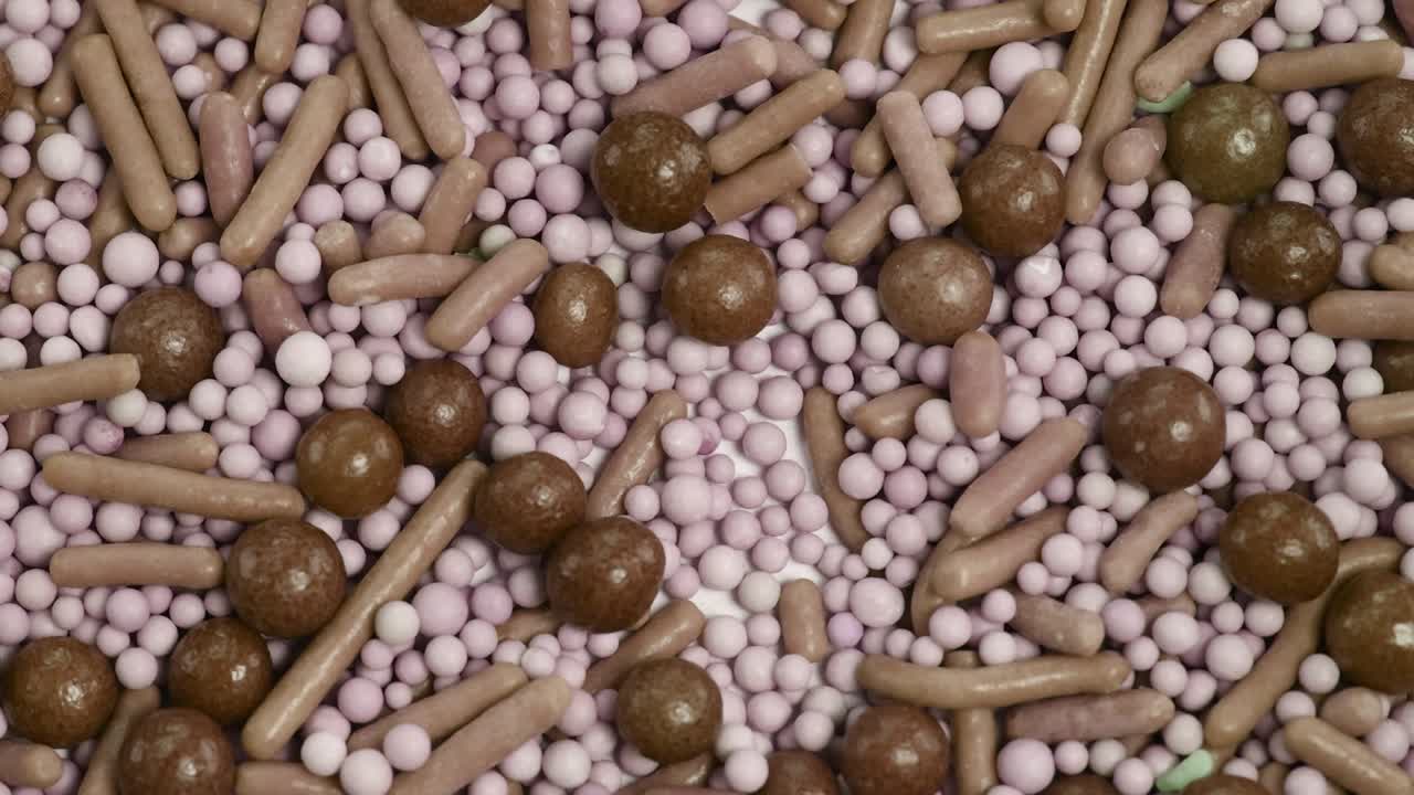 A detailed macro view of assorted candies, featuring vibrant colors and varied shapes, creating a playful and sweet visual experience