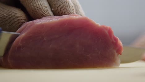 slicing raw pork tenderloin