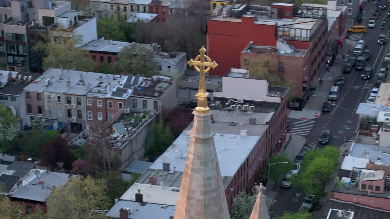 Aerial view of a crucifix on a church steeple in Brooklyn. Shot on a spring day.