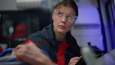 Paramedic-writing-diagnosis-of-victim-on-clipboard.-Doctor-examining-patient