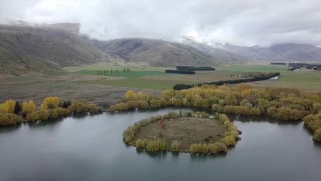 scenic autumn landscape with island lake and mountains