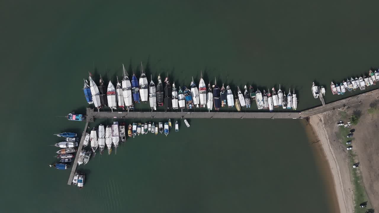 Overhead View Of Boats Docked Along A Pier In Paraty, Brazil. - aerial shot
