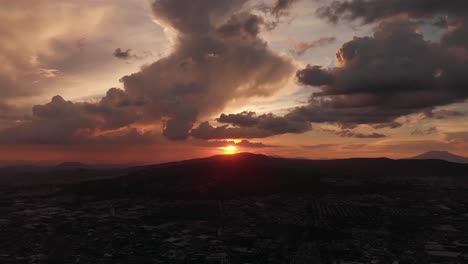 aerial: sunset over the city with clouds